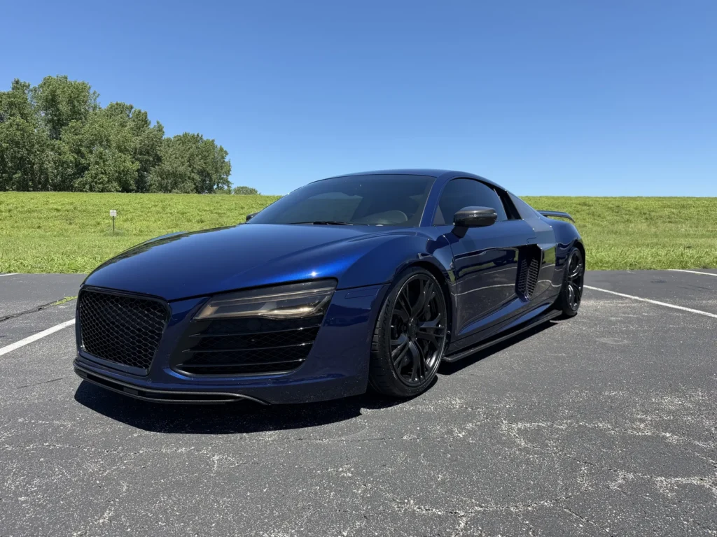 Black Audi R8 with window tint, front quarter view